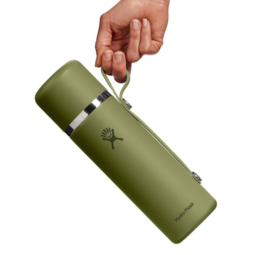Olive-green Hydro Flask thermos with smooth matte finish, silver metallic band near top, matching side handle, and Hydro Flask logo. Sleek cylindrical design.