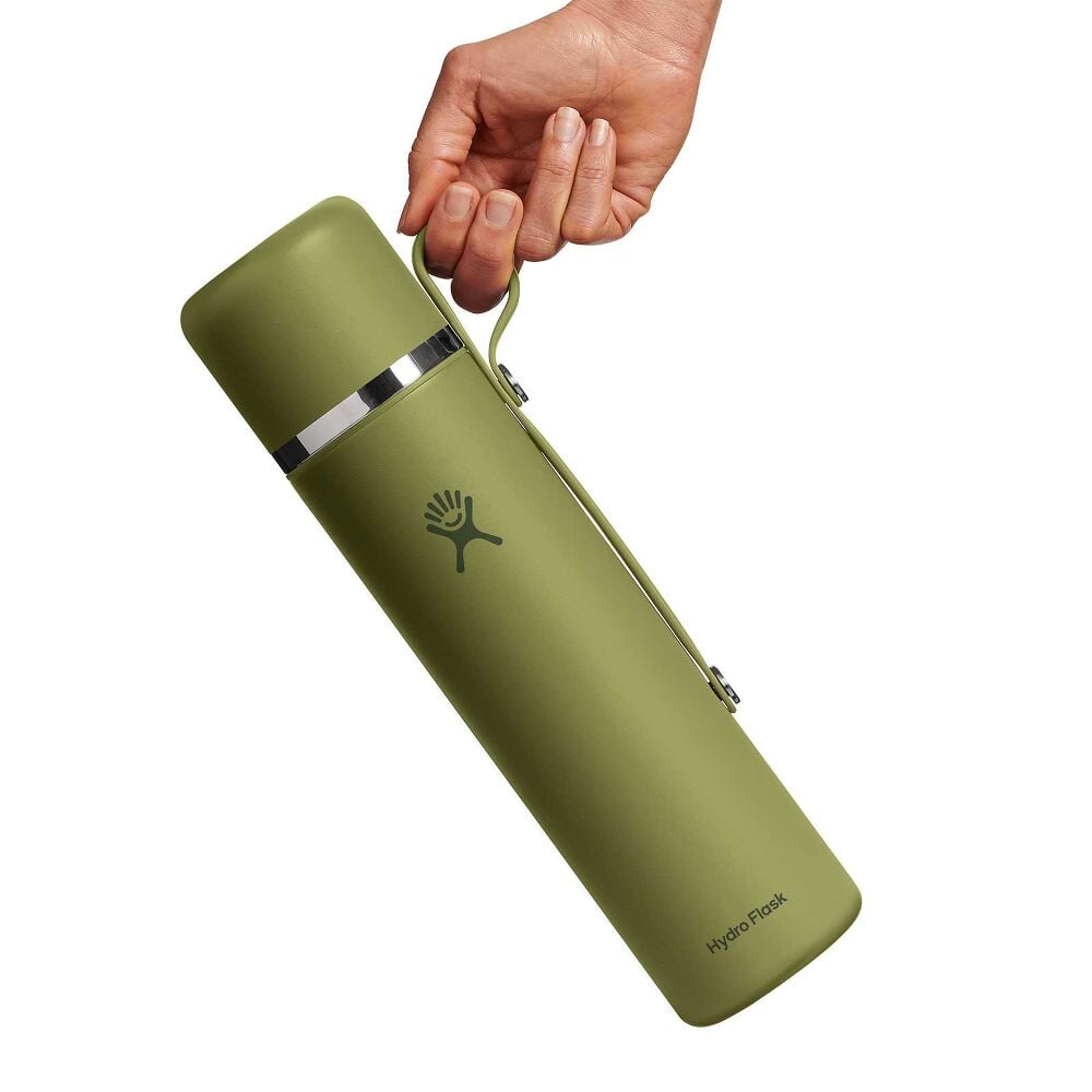 Olive-green Hydro Flask insulated thermos-style bottle with smooth matte finish, shiny silver band near top, matching green side handle, and logo on front.