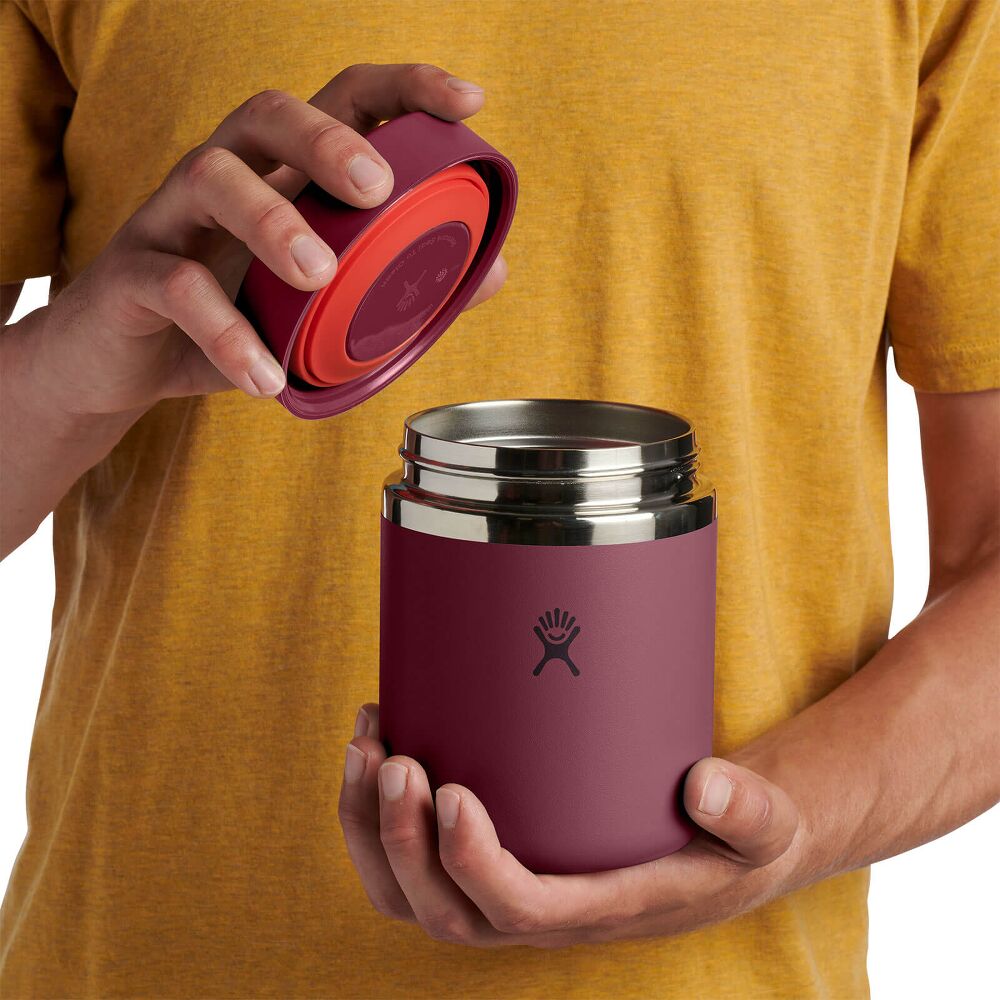 Maroon Hydro Flask cylindrical insulated food container with matching screw-on lid, brushed metal band, matte finish, and Hydro Flask logo on front.