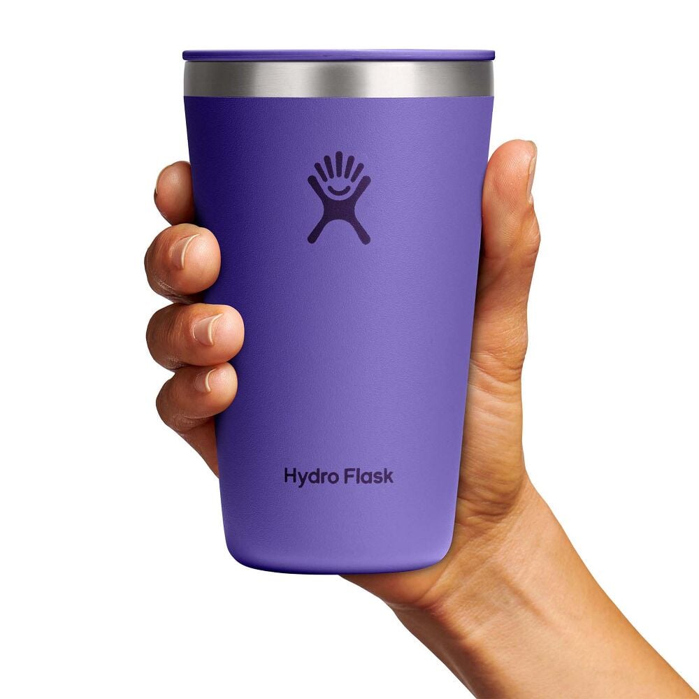 Purple Hydro Flask insulated tumbler with matching lid, brushed stainless steel rim, small sip opening, matte finish, and Hydro Flask logo on front.